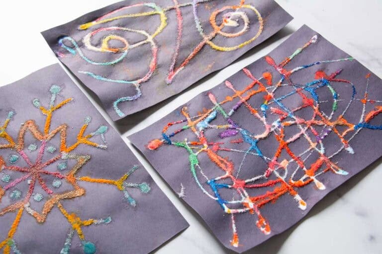 raised salt paintings on black paper.