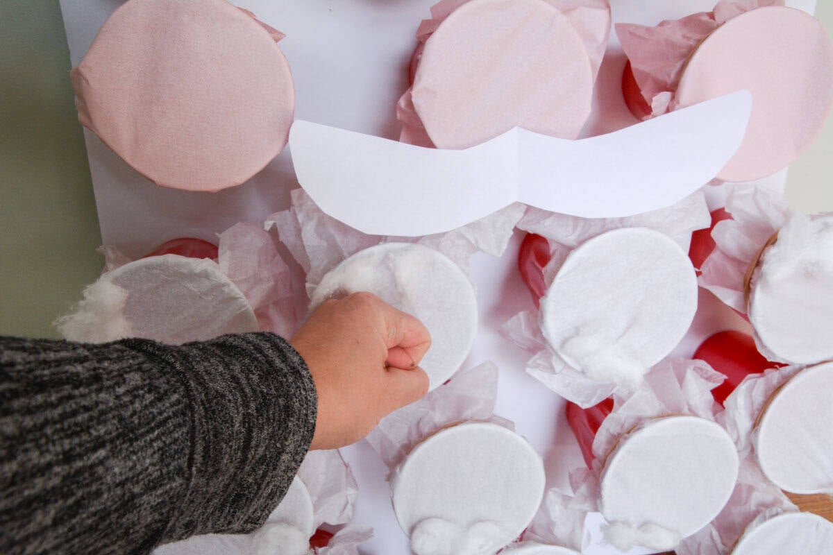 hand making a fist to punch a Christmas punch board game.
