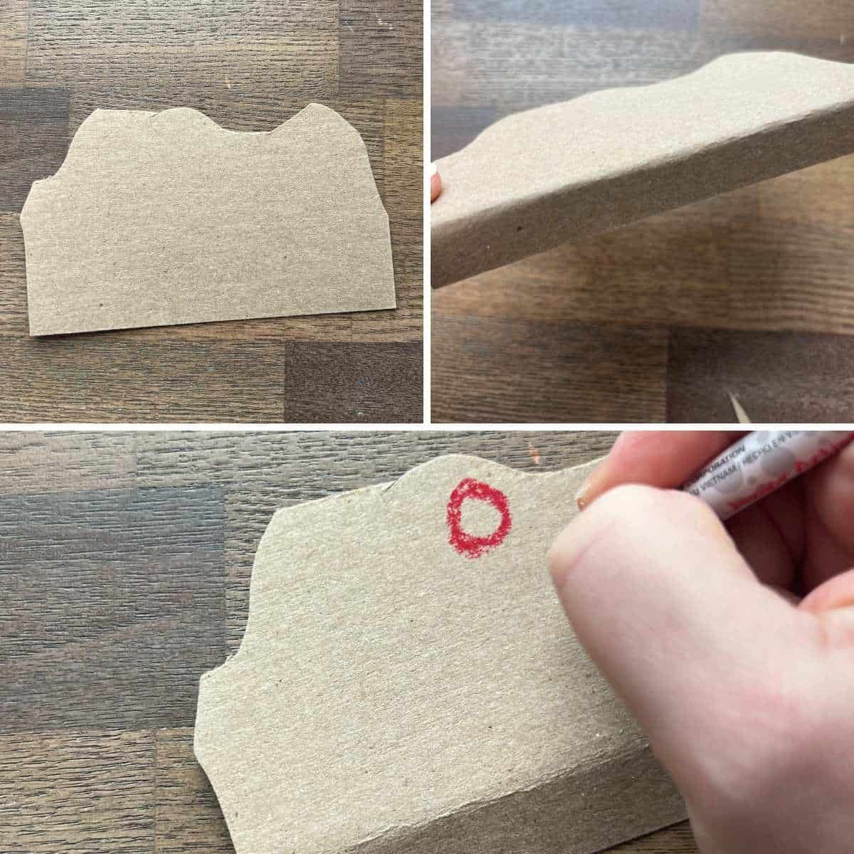 cardboard shape being cut and drawn on.