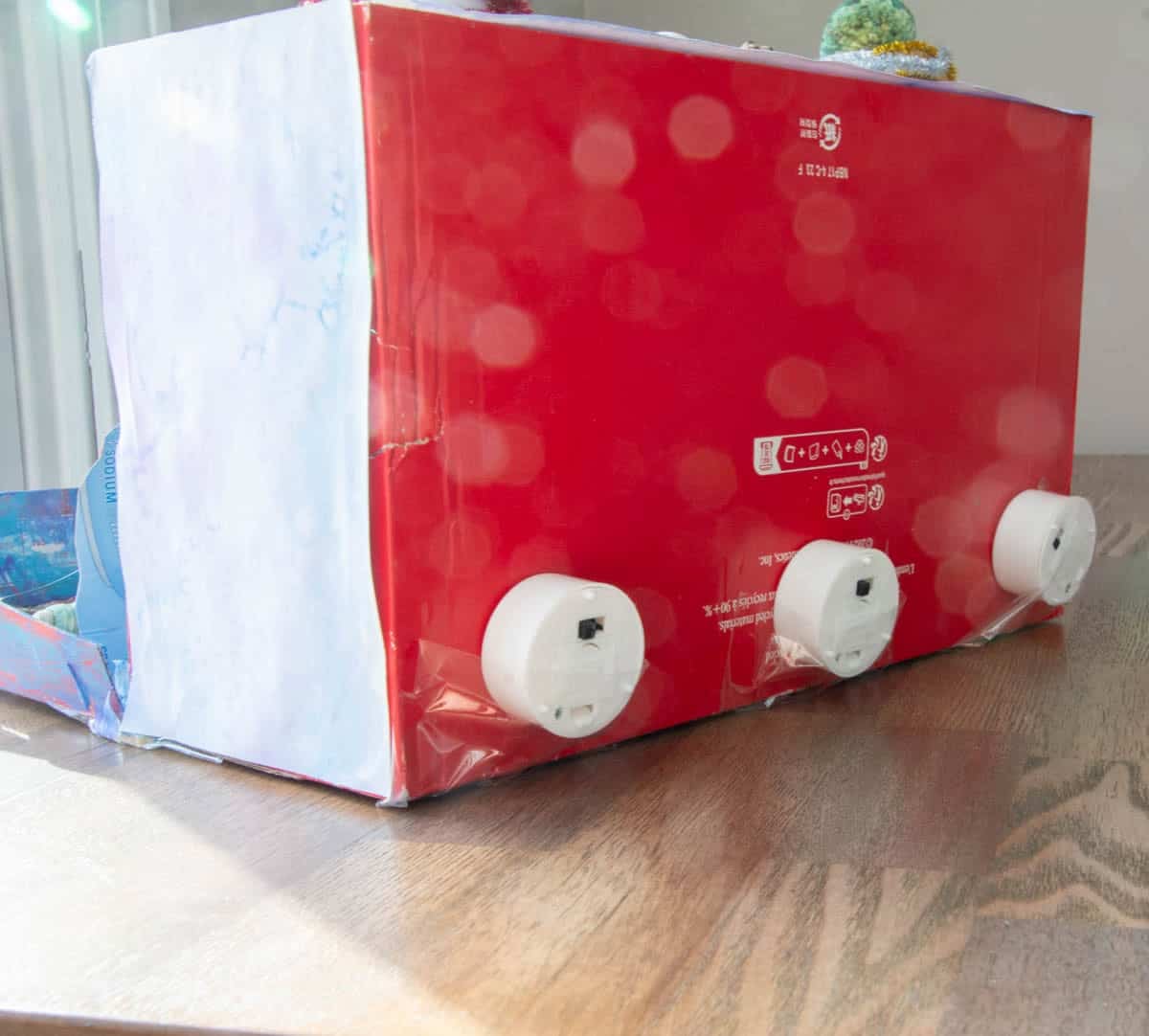 teal lights into the back of a shoe box.