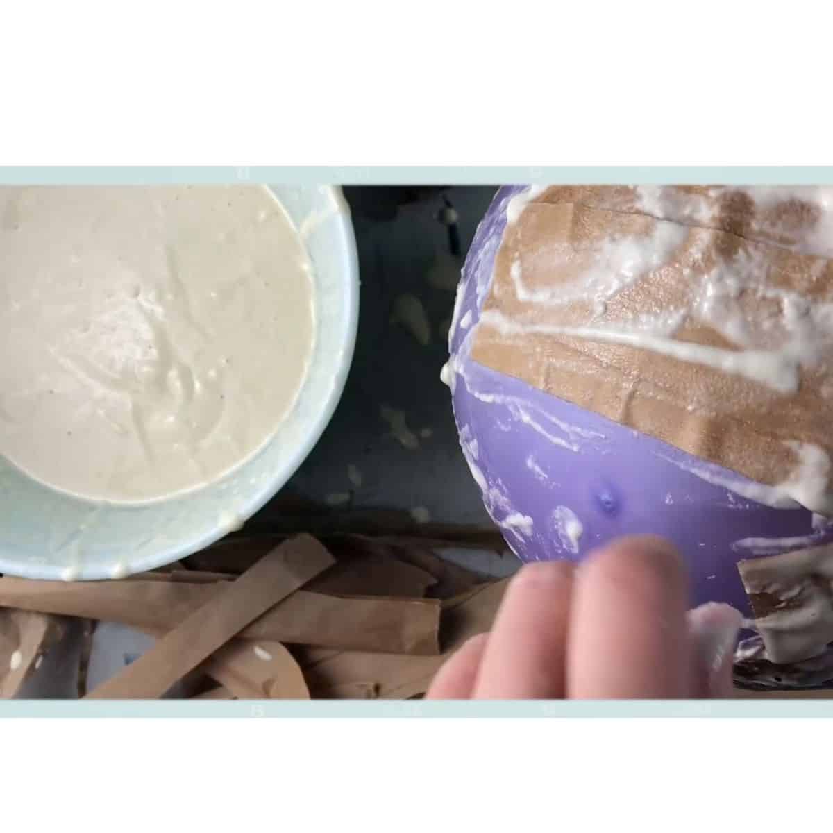 hands covering balloon.