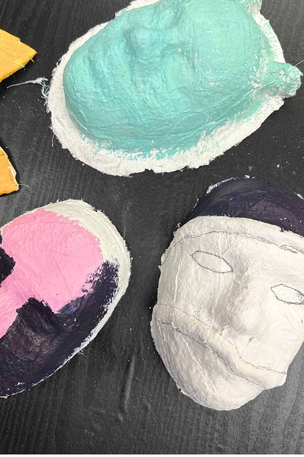 plaster cloth mask projects on a table.