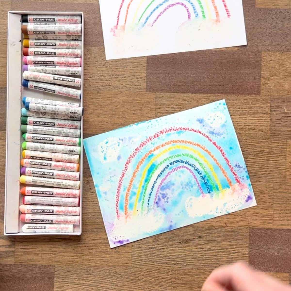rainbow oil pastel drawing and painting on a table.