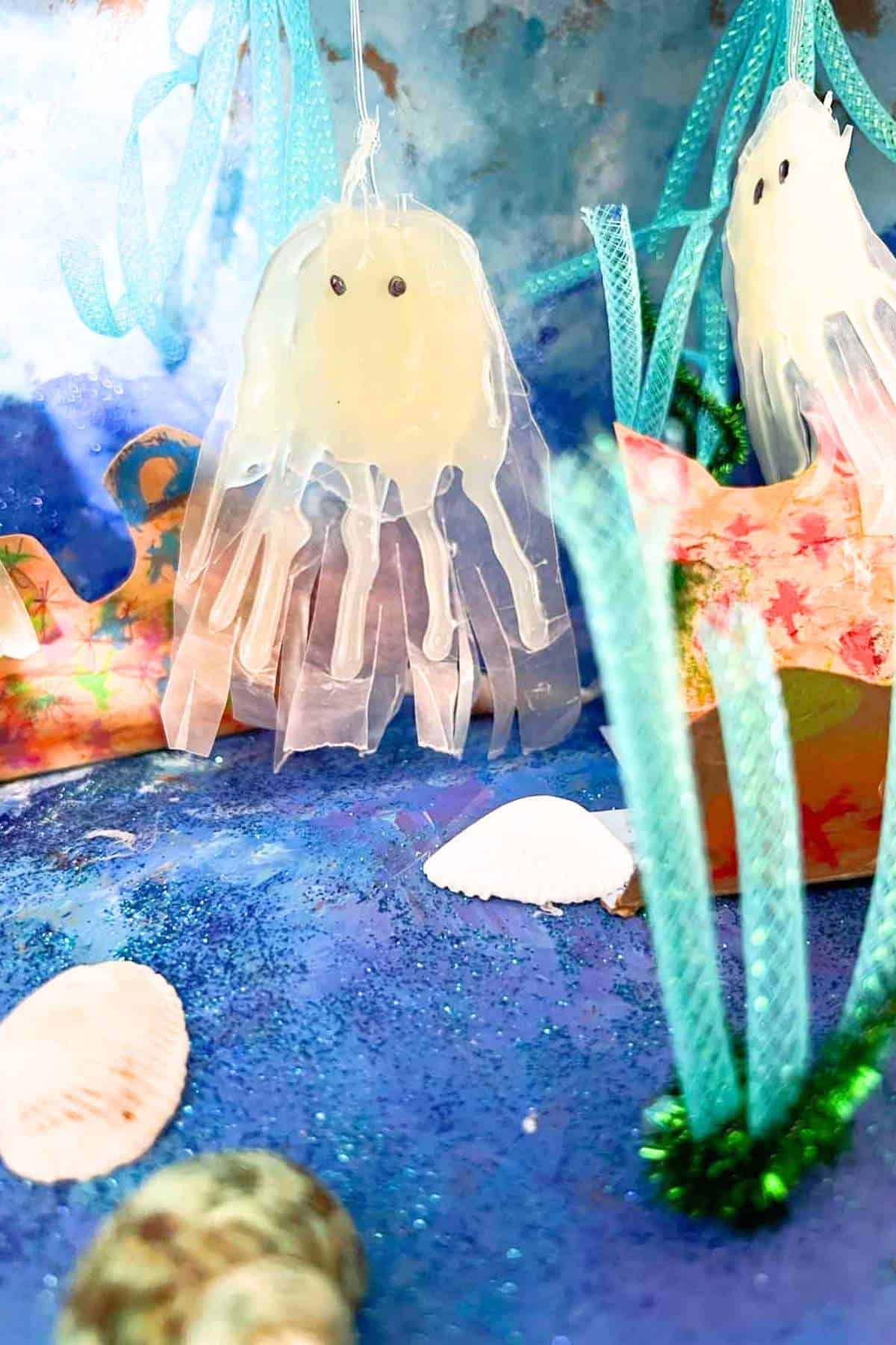 jellyfish craft hanging in painted decorated shoebox ocean habitat.