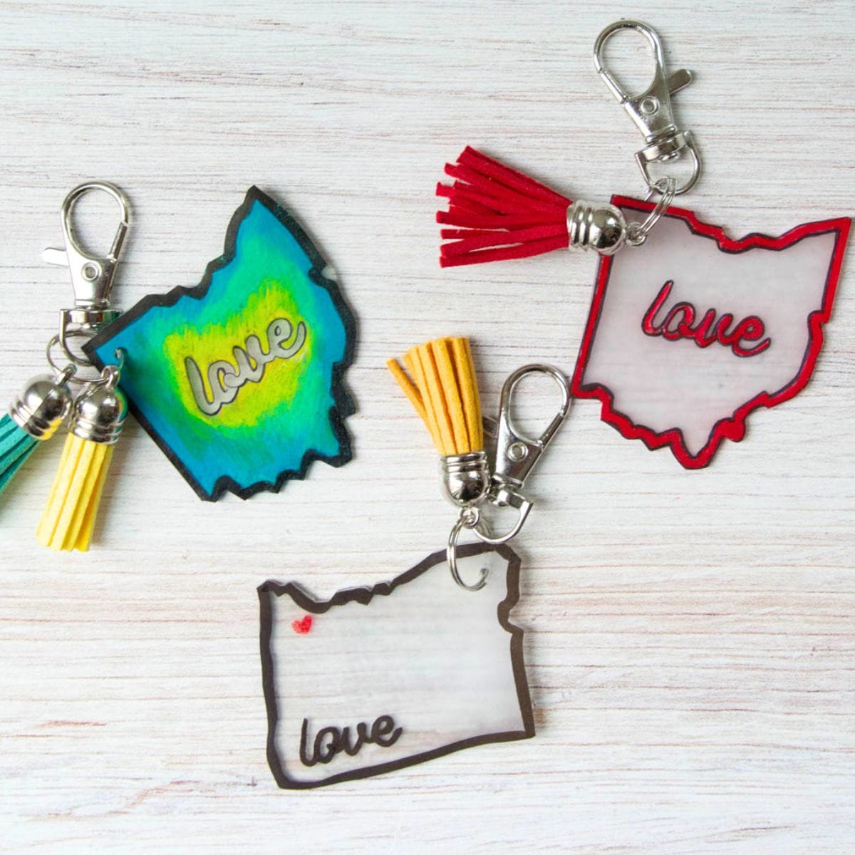 3 different state keychain crafts on a table.