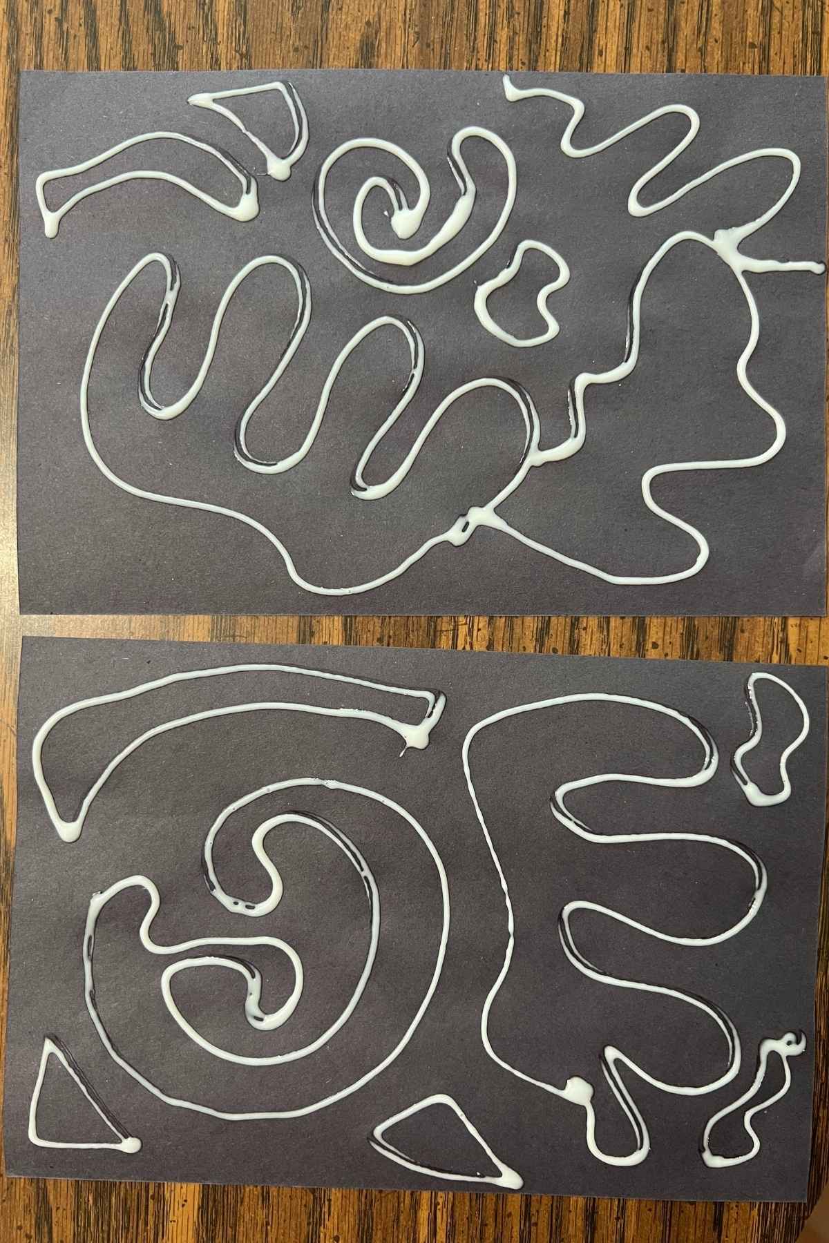 glue drawings on black paper.
