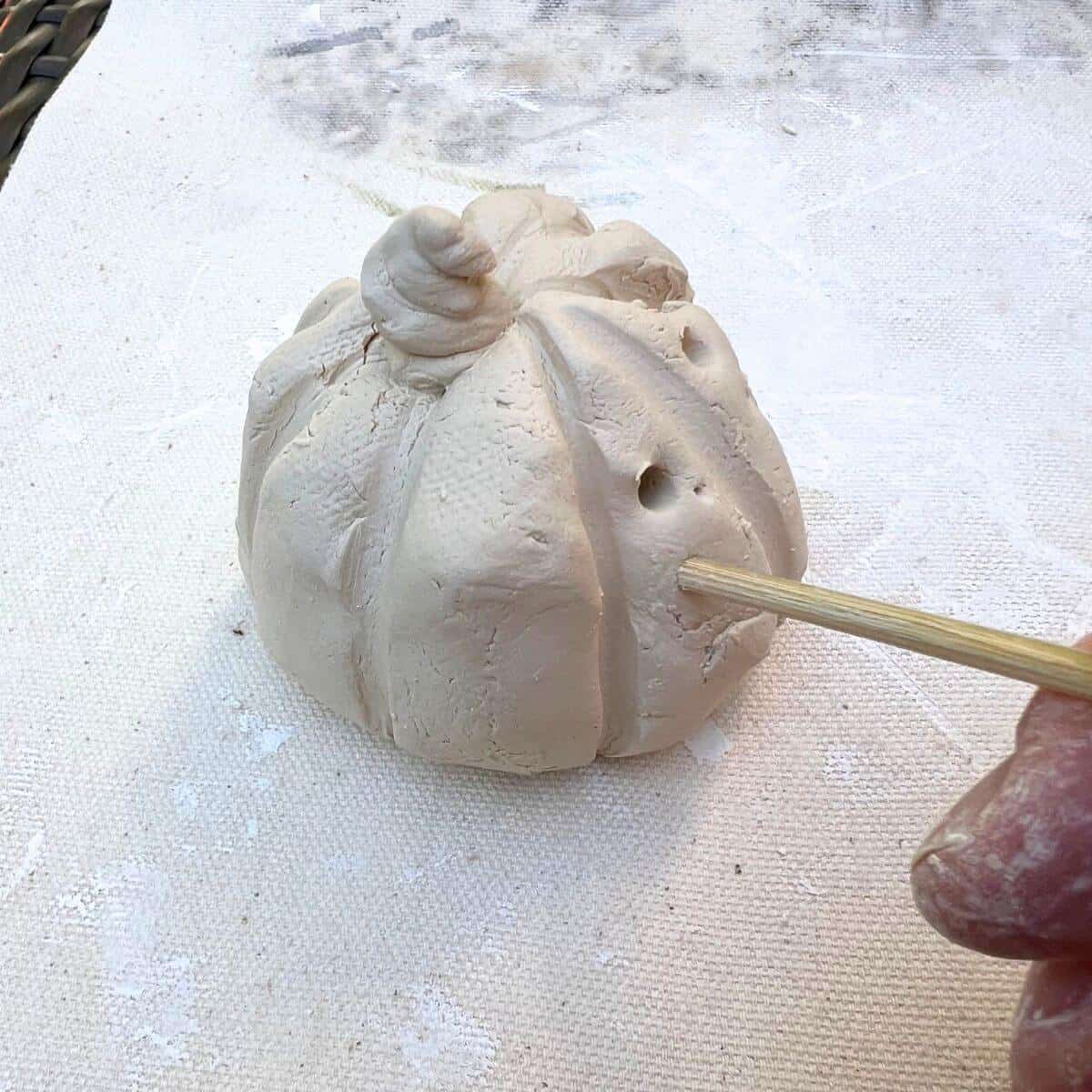 wooden stick added polka pattern to pumpkin.