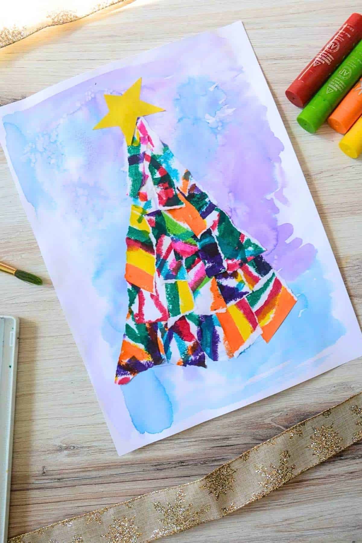 colorful Christmas tree collage on painted paper.
